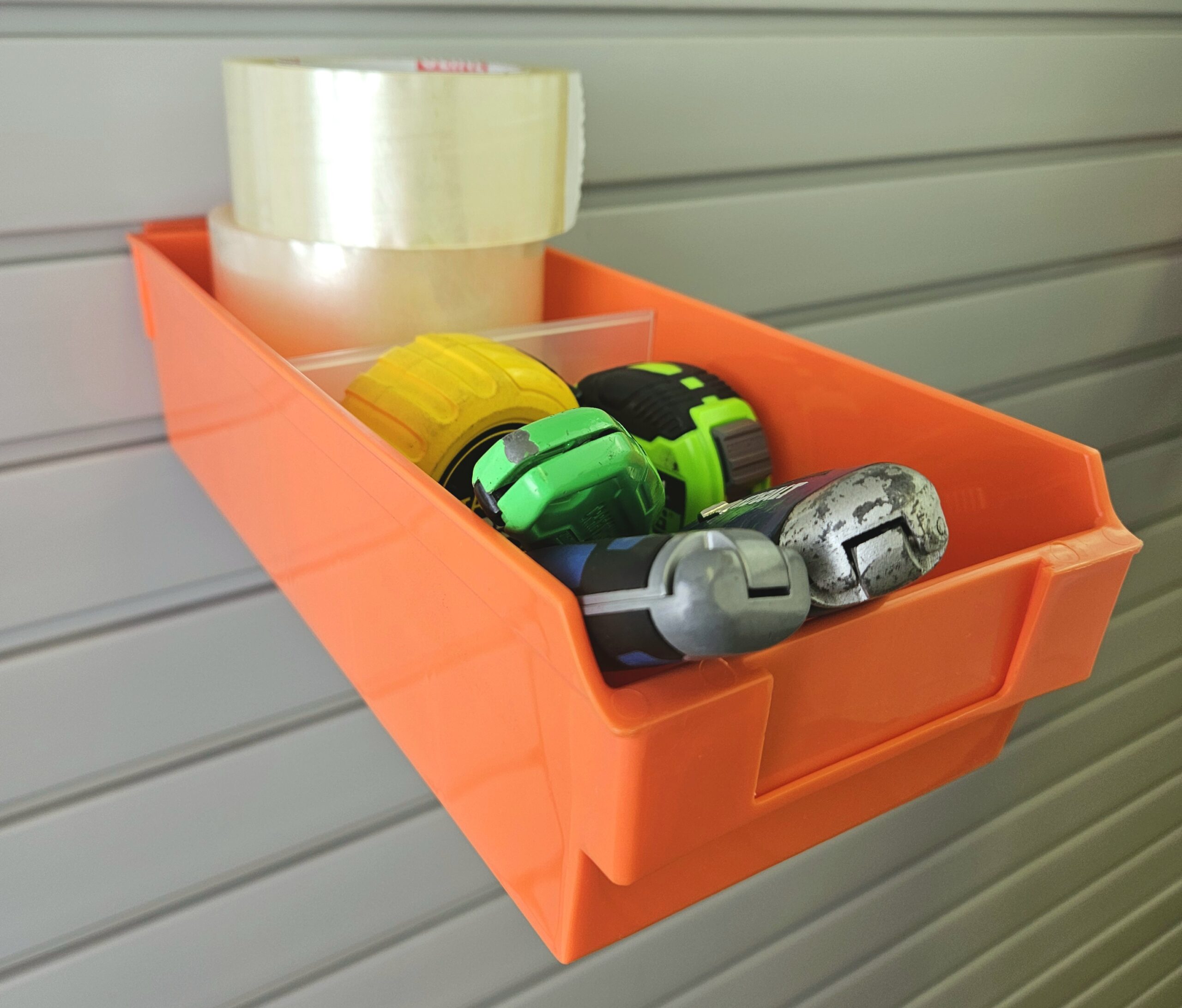 Orange Shelfbox 300 holding tape, measuring tapes, and box cutters