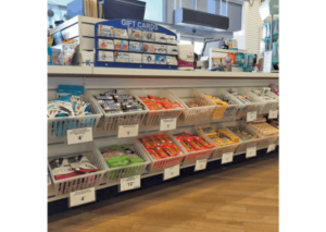 A candy display at a retail store with clear Cratebox Tilt Mediums holding candy